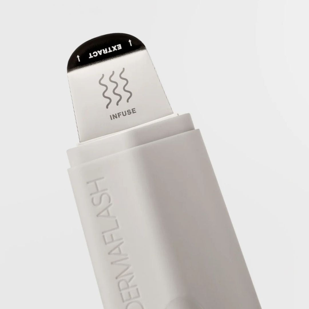 DERMAFLASH skin rejuvenation tools displayed on a bathroom counter, designed for at-home exfoliation and dermaplaning.