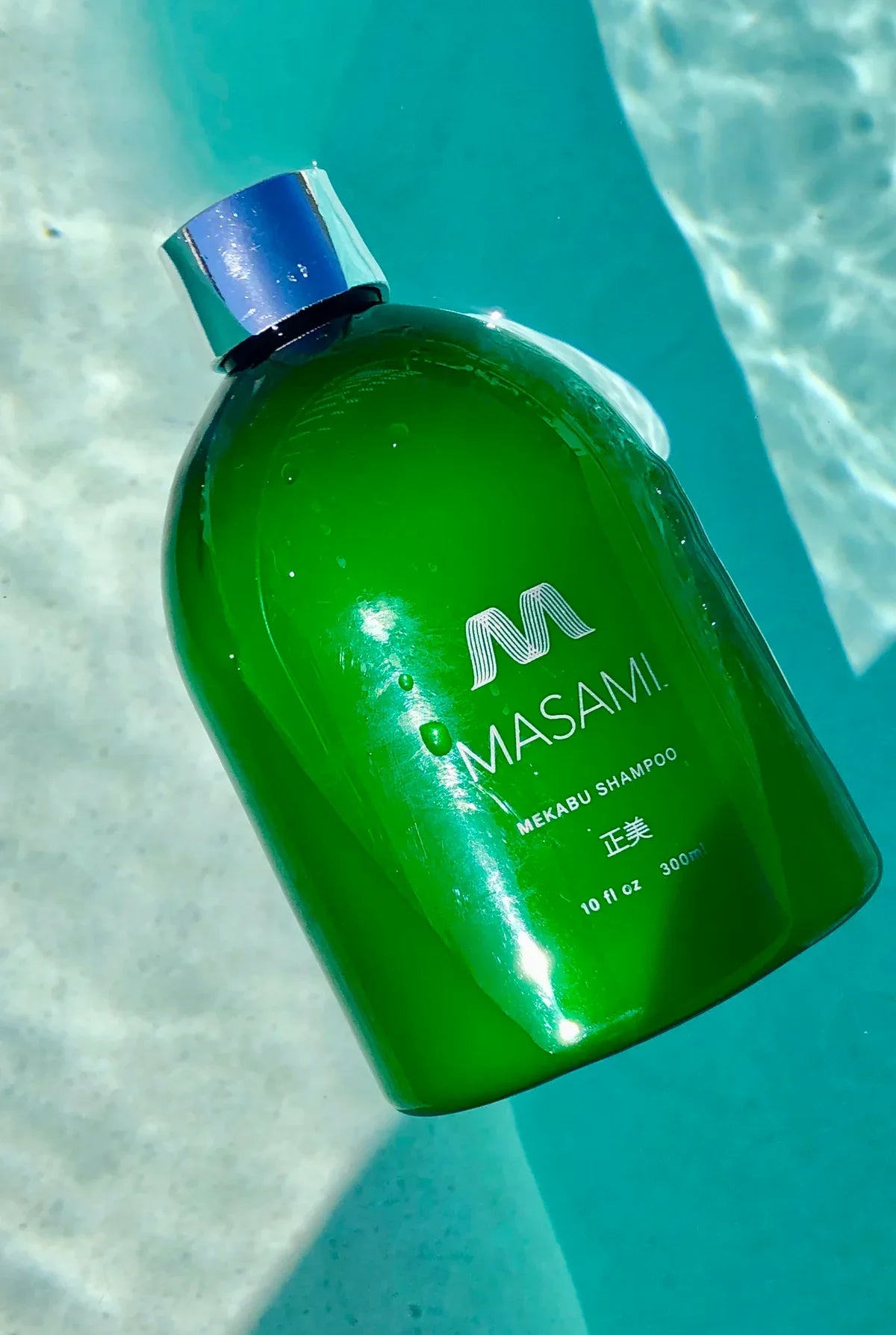 MASAMI haircare products with Mekabu seaweed displayed in a minimal, ocean-inspired setting