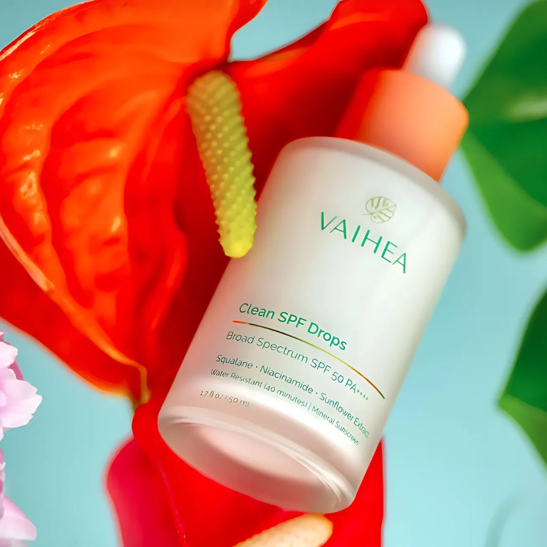 Flatlay of Vaihea Skincare products on natural linen with tropical botanicals, evoking clean beauty and island-inspired rituals.