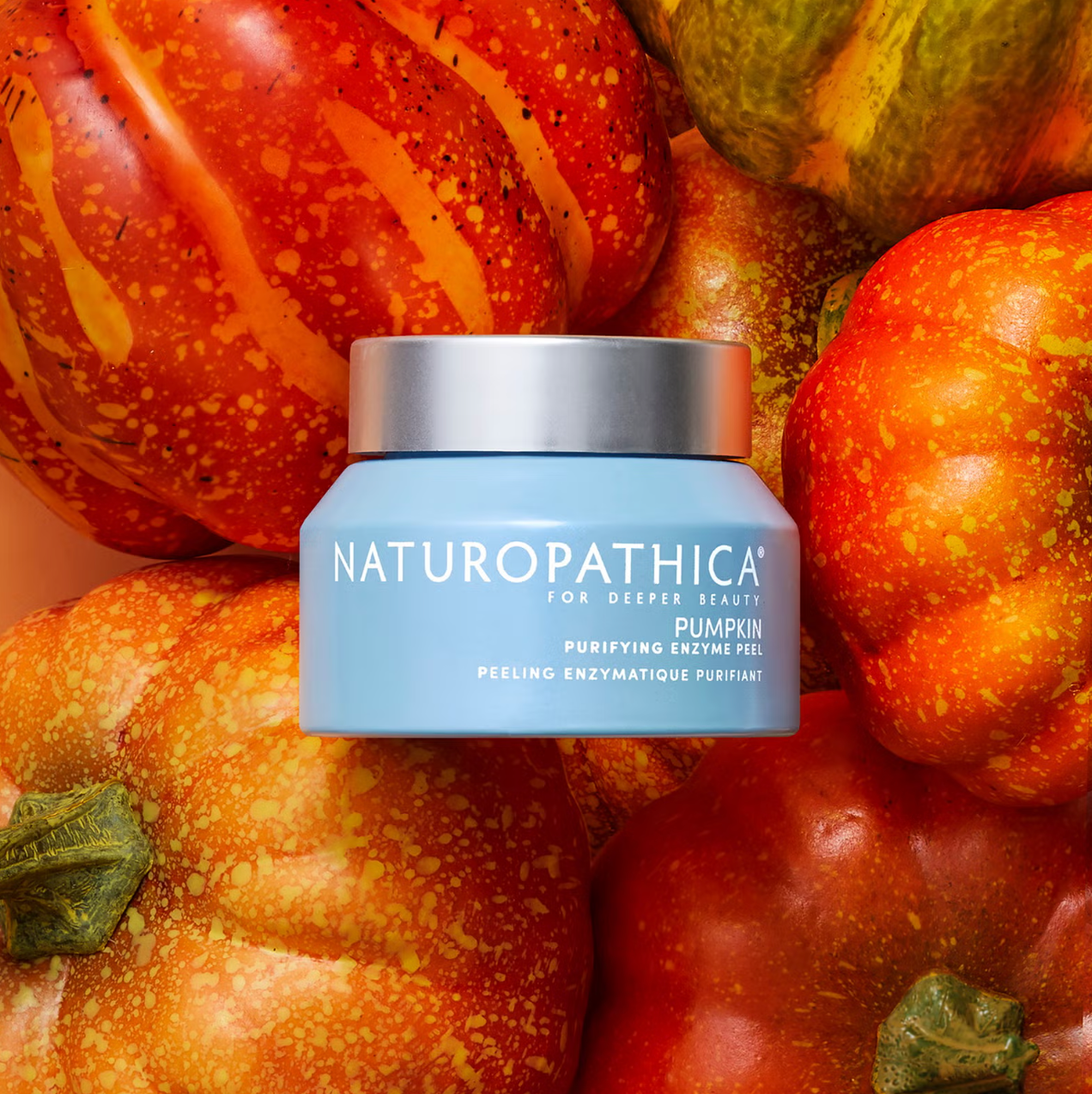Naturopathica pumpkin facial product jar surrounded by pumpkins