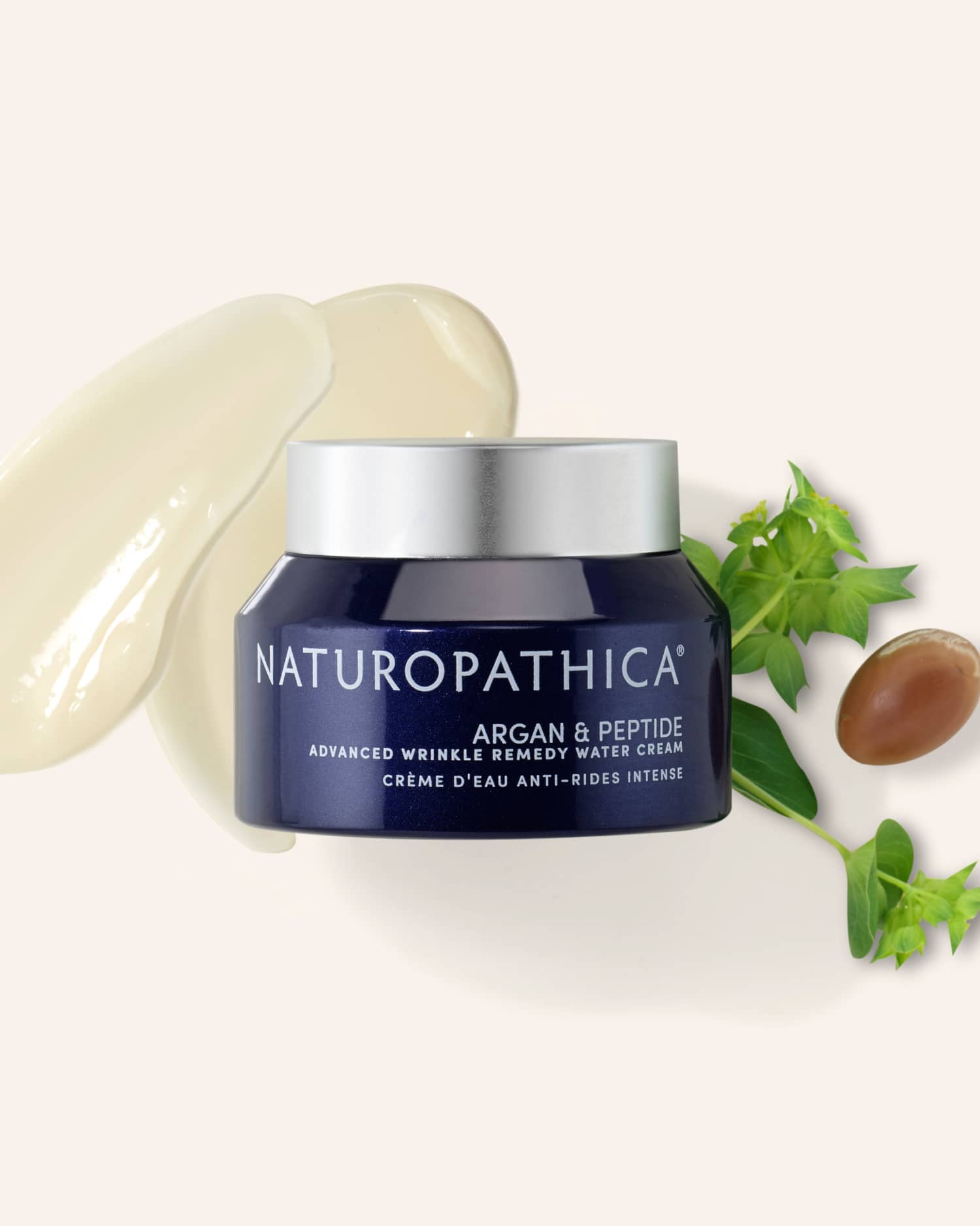 Open jar of Naturopathica Argan & Peptide Wrinkle Remedy Water Cream with a smooth swirl texture, styled with botanical accents for anti-aging hydration