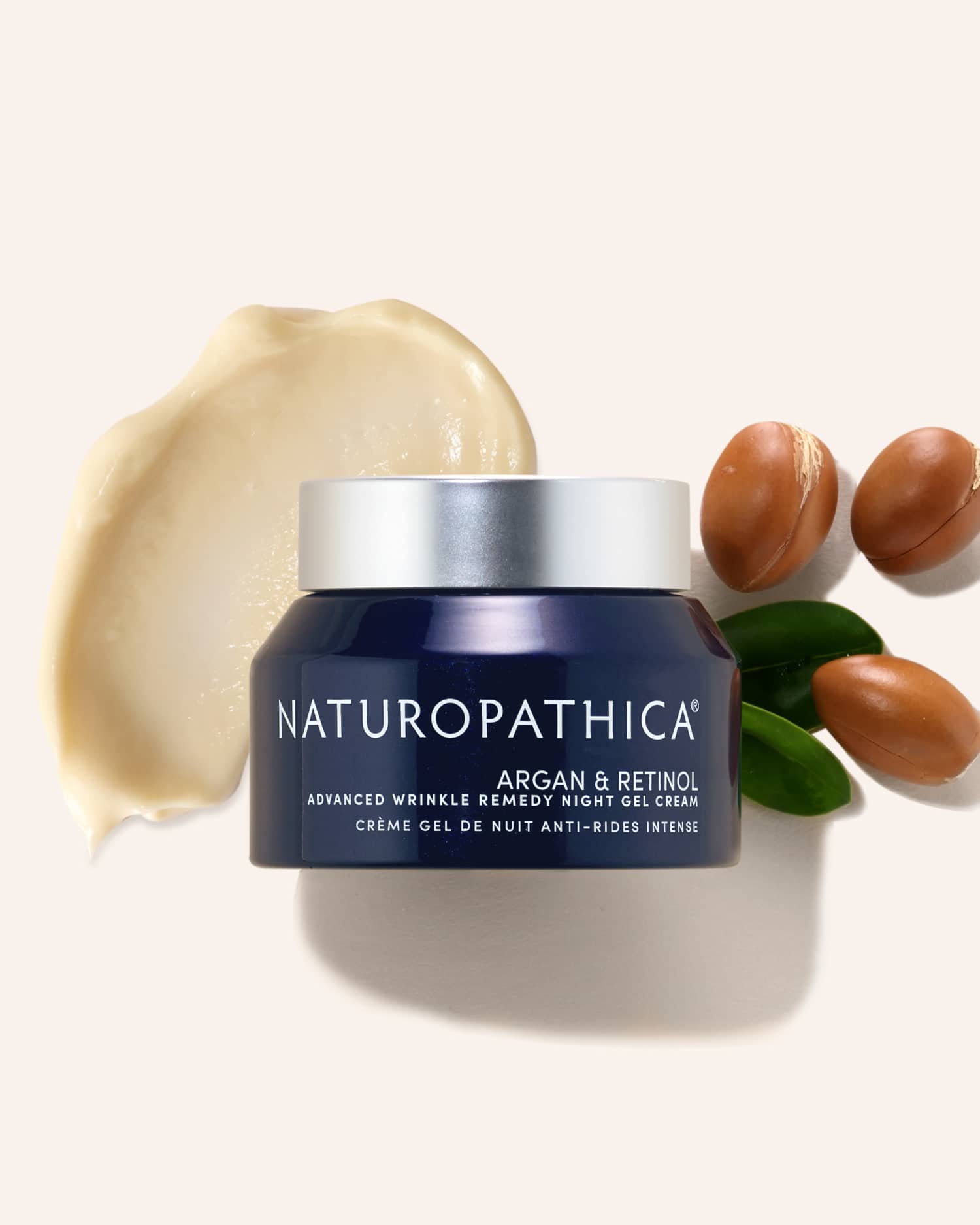 Open jar of Naturopathica Argan & Retinol Advanced Wrinkle Remedy Night Gel Cream on a bedside surface, styled for overnight skin renewal and firming

