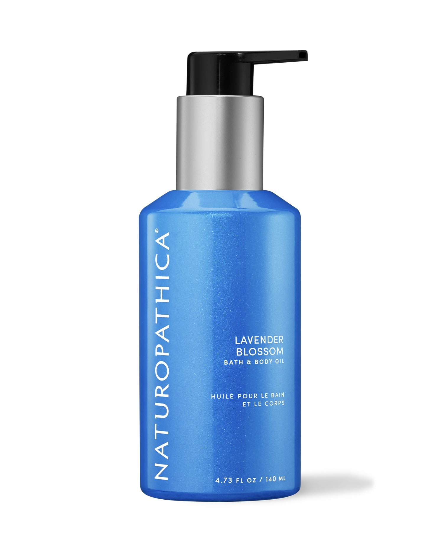Bottle of Naturopathica Lavender Blossom Bath & Body Oil placed beside fresh lavender and a bath towel, styled for calming body and skincare ritual