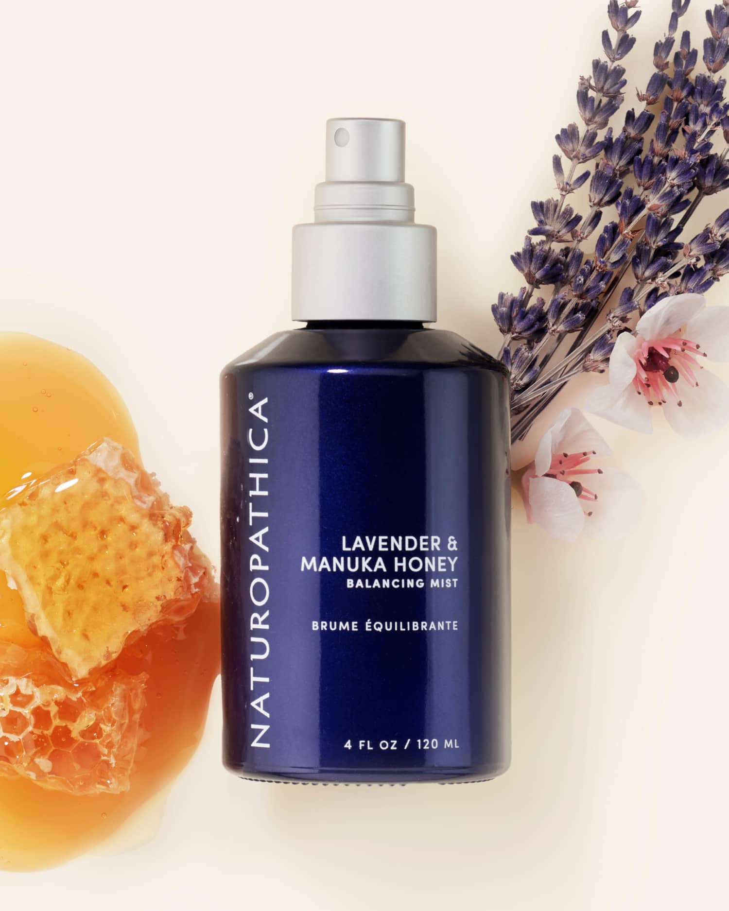 Bottle of Naturopathica Lavender & Manuka Honey Balancing Mist on a neutral surface with lavender sprigs, styled as a soothing toner and hydrating facial mist

