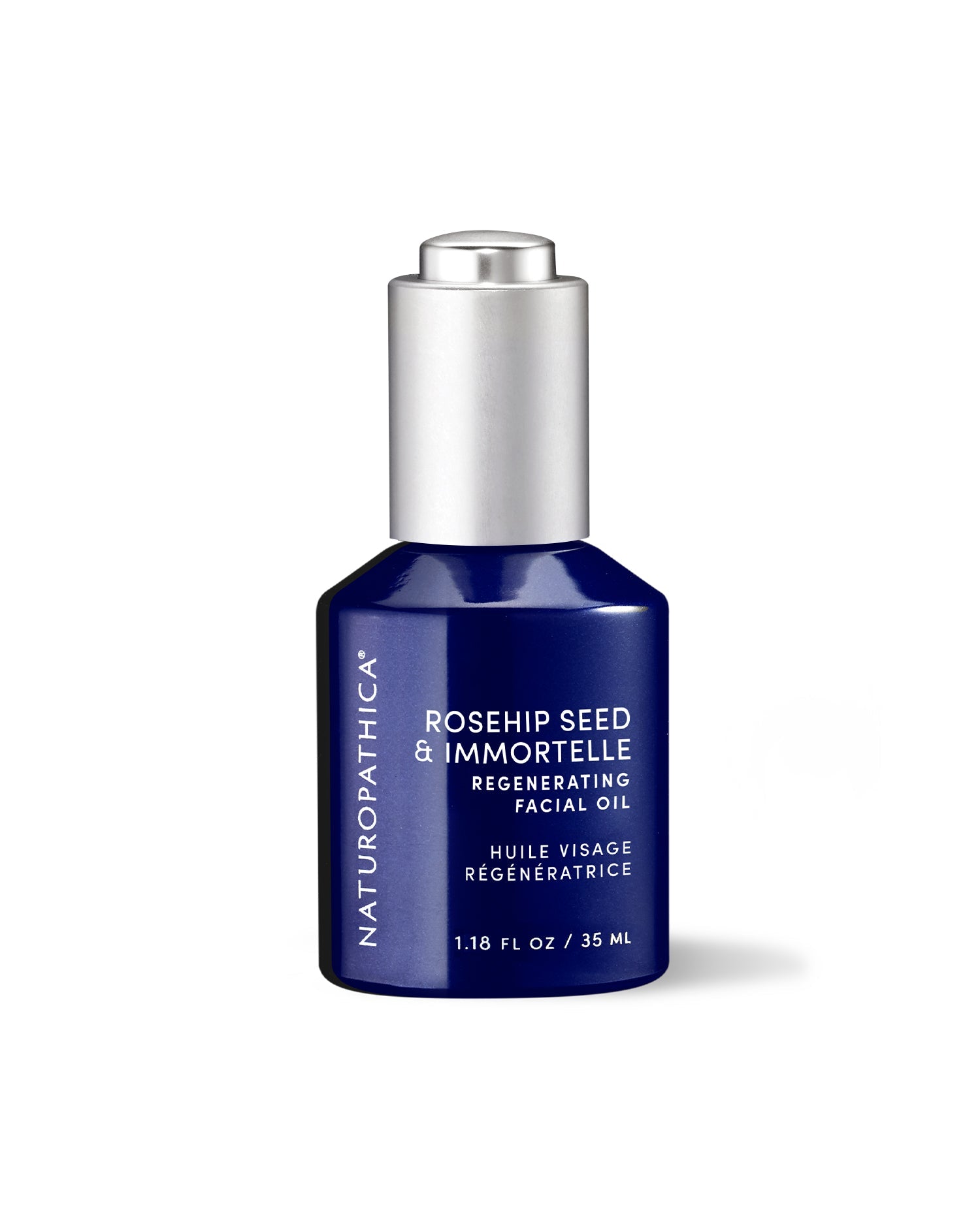 Amber glass bottle of Naturopathica Rosehip Seed & Immortelle Regenerating Facial Oil on a neutral background with botanicals, promoting hydration and glow

