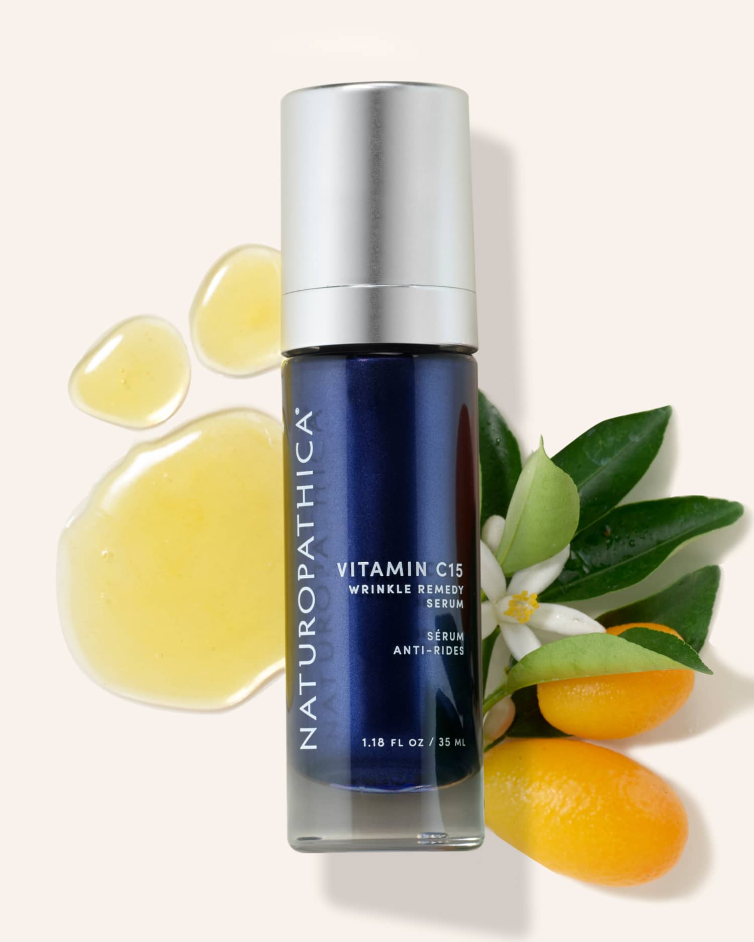 Amber dropper bottle of Naturopathica Vitamin C15 Wrinkle Remedy Serum on a light background with citrus and floral elements, styled for brightening skincare